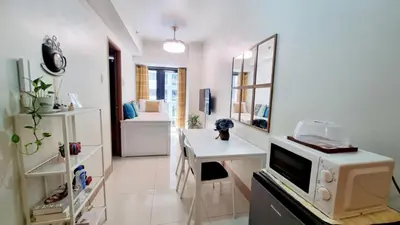 a living room with a desk and a mirror at Shore 3 Residences Mall of Asia Pool view Netflix free wifi in Manila