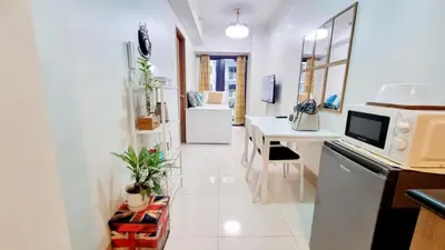 a kitchen with a microwave and a desk in it at Shore 3 Residences Mall of Asia Pool view Netflix free wifi in Manila