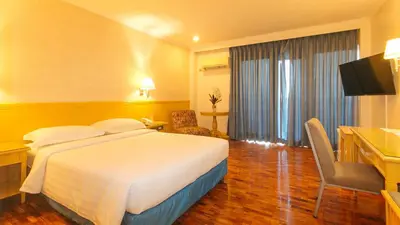 a hotel room with a bed and a desk at Aloha Hotel Roxas Boulevard Manila in Manila