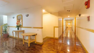 an empty hallway with a table and a stool at Aloha Hotel Roxas Boulevard Manila in Manila