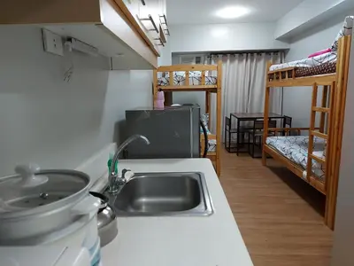 a kitchen with a sink and a kitchen with bunk beds at Bunked Bed Room Sharing in Manila