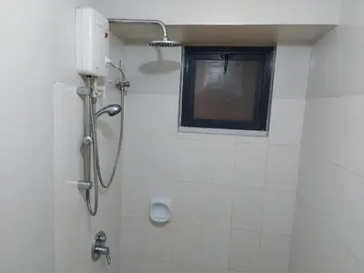 a shower in a bathroom with a window at Bunked Bed Room Sharing in Manila