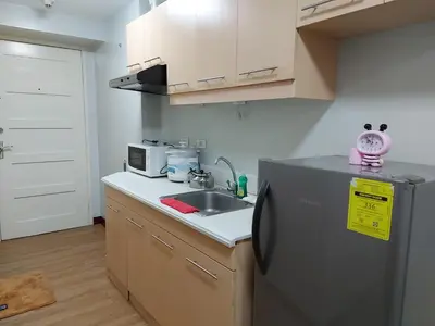 a small kitchen with a sink and a refrigerator at Bunked Bed Room Sharing in Manila