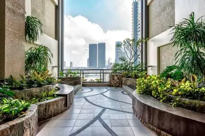 a building with a balcony with a view of the city at Male Room Sharing in Manila