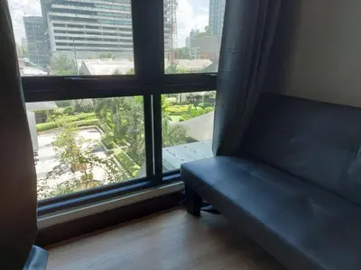 a couch in front of a window with a view at Male Room Sharing in Manila