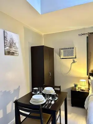 a room with a table with plates on it at 22-A Cozy condo in KL Mosaic Residences near Greenbelt with free WIFI in Manila