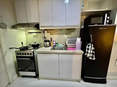 a small kitchen with a sink and a refrigerator at 22-A Cozy condo in KL Mosaic Residences near Greenbelt with free WIFI in Manila