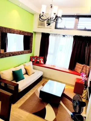 a living room with a couch and a table at The Levels 2BR Condo Fully Interior Cosmo Living in Manila