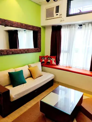 a living room with a couch and a table at The Levels 2BR Condo Fully Interior Cosmo Living in Manila