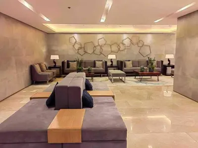 a lobby with couches and couches in a building at MoA S Residences Family Suite with balcony in Manila