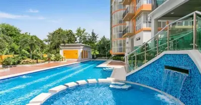 an empty swimming pool in front of a building at Lancris Residences 2 Bedroom Entire Apartment near Airport with Pool in Manila