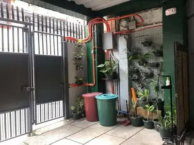 a room with a bunch of potted plants on a wall at Adorable Lounge - 1 Bedroom loft w/home cinema in Manila