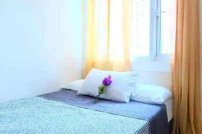 a purple flower sitting on top of a bed at StayHere SM Light by Boni MRT along EDSA in Manila