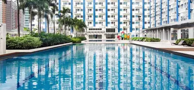 a large swimming pool in front of a building at StayHere SM Light by Boni MRT along EDSA in Manila