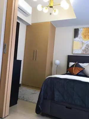 a bedroom with a bed and a ceiling fan at Daniella’s Modern & Cozy Suite in Uptown BGC in Manila