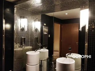 a bathroom with two sinks and two urinals at The Knightsbridge Residences in Manila
