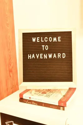 a sign that reads welcome to haveward sitting on books at Fully furnished condo in Quezon City in Manila