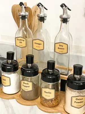 a group of glass bottles on a shelf with spices at Fully furnished condo in Quezon City in Manila