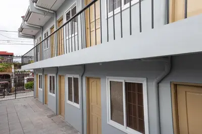 a row of doors and windows on a building at Hive Manila Guesthouse and Apartments 400 Mbps - Gallery Studio in Bacoor