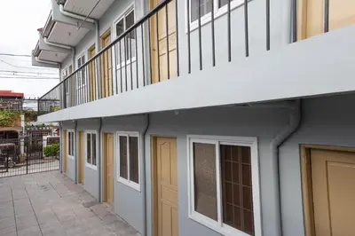 a row of doors and windows on a building at Hive Manila Guesthouse and Apartments 400 Mbps - Gallery Studio in Bacoor