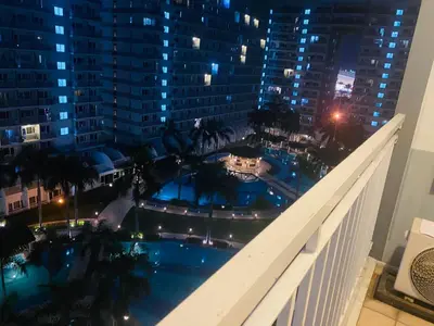 a view of a pool from the balcony of a building at Shell Residences C16 Shortwalk Sm Mall Of Asia/Airport in Manila
