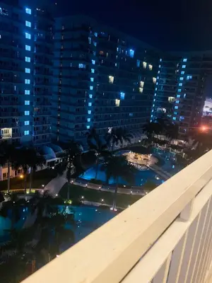 a view of a pool at night from a building at Shell Residences C16 Shortwalk Sm Mall Of Asia/Airport in Manila