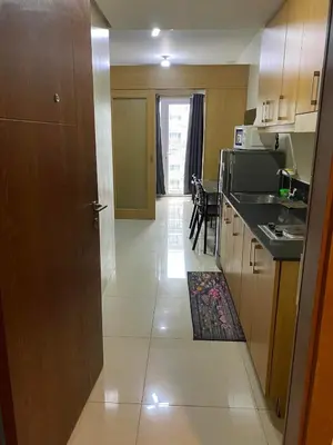 a kitchen with a door leading to a dining room at Shell Residences C16 Shortwalk Sm Mall Of Asia/Airport in Manila