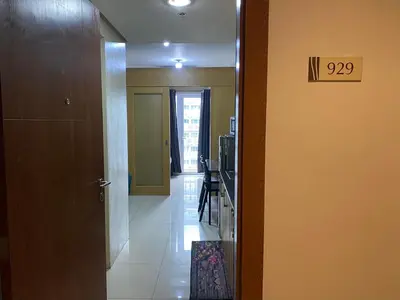 a hallway with a door to a room with a kitchen at Shell Residences C16 Shortwalk Sm Mall Of Asia/Airport in Manila