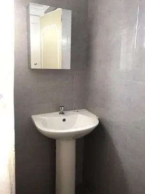 a bathroom with a white sink and a mirror at Alta Vitas Daily in Manila