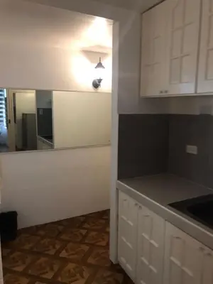 a kitchen with white cabinets and a counter top at Alta Vitas Daily in Manila