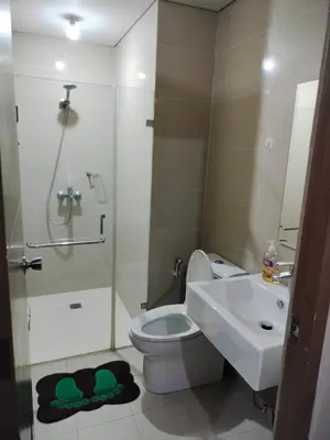 a bathroom with a toilet and a sink and a shower at Room Across NAIA Terminal 3 at Newport in Manila