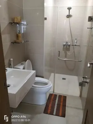 a bathroom with a shower and a toilet and a sink at Staycation Near Airport and resorts World Manila in Manila