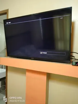 a flat screen tv sitting on top of a table at Staycation Near Airport and resorts World Manila in Manila