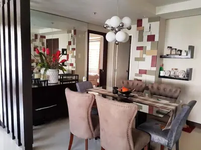 a dining room with a table and chairs at McKinley Hill, BGC 3 Bedroom Unit Venice Mall Walking Distance in Manila