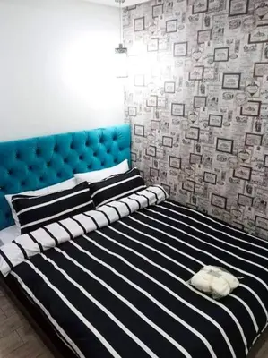 a black and white bed with a cat sleeping on it at McKinley Hill, BGC 3 Bedroom Unit Venice Mall Walking Distance in Manila