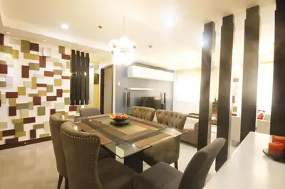 a dining room with a table and chairs at McKinley Hill, BGC 3 Bedroom Unit Venice Mall Walking Distance in Manila