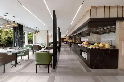a restaurant with tables and chairs and a kitchen at The Westin Manila in Manila