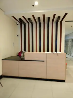 a bed in a room with stripes on the wall at Condotel Pasay Newport Near Airport in Manila