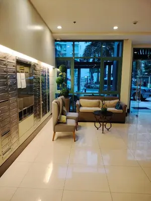 a lobby with couches and chairs in a building at Condotel Pasay Newport Near Airport in Manila