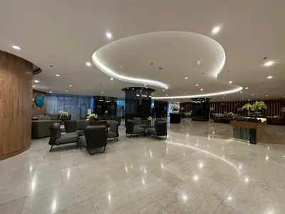 a lobby with couches and chairs in a building at Homey Condo by the Bay in Manila