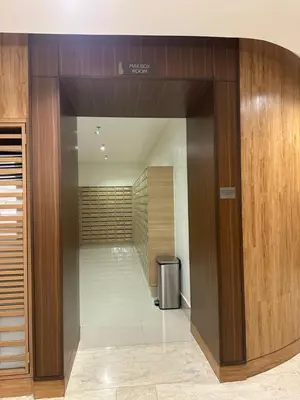 a hallway in a building with a trash can at Homey Condo by the Bay in Manila