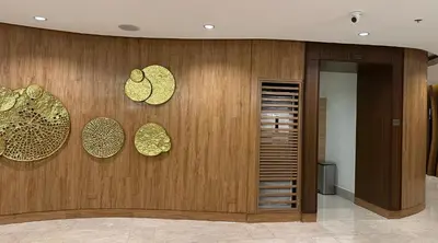 a lobby with wooden walls with gold hearts on it at Homey Condo by the Bay in Manila