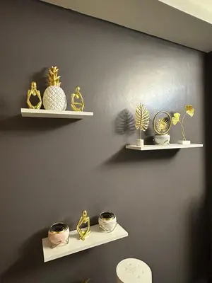 a wall with shelves with vases and plants on them at Kathys crib 32sqm Condo Shell Residences in Manila
