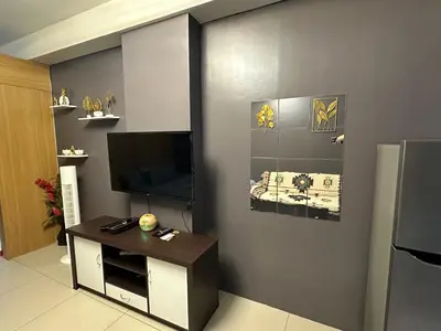 a living room with a flat screen tv on a wall at Kathys crib 32sqm Condo Shell Residences in Manila