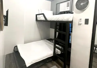 a small room with two bunk beds in it at mySTAY Hotel BGC South in Manila