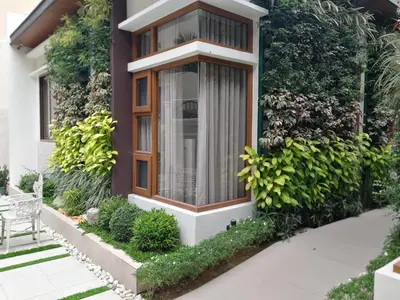 a house with a window and green plants at Adria Residences - Sapphire Garden - 2 Bedroom for 4 person in Manila