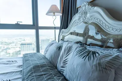 a bedroom with a white bed with a window at A2J Luxury 2BR BGC Uptown Suite Near Uptown Mall in Manila