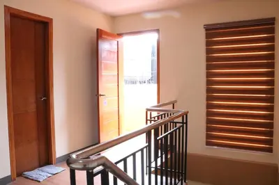 a staircase with a wooden door and a window at Anicia Guesthouse Rooms in Manila
