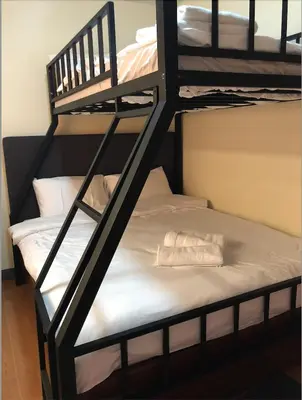 a bunk bed room with a bunk bed with a bunk bed at Anicia Guesthouse Rooms in Manila