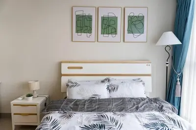 a bedroom with a bed and two pictures on the wall at A2J Luxury 3BR Uptown Balcony BGC Suite Near Mall in Manila